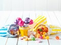 Assortment of candies in bags and cup over a table