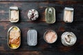 Assortment of cans of canned with different types of fish, on old dark  wooden table background., top view flat lay Royalty Free Stock Photo