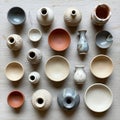 An assortment of ceramic pots and bowls displayed on a light wooden surface Royalty Free Stock Photo