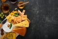 Assortment of cheese, honey, cracker, blueberries, grapes with red and white wine in glasses antipasto server on white marble boar Royalty Free Stock Photo