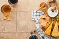 Assortment of cheese, honey, cracker, blueberries, grapes with red and white wine in glasses antipasto server on white marble boar Royalty Free Stock Photo