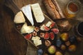 Assortment of cheeses, glass red wine, figs, honey, nuts and bread on wooden table Royalty Free Stock Photo