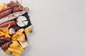 Assortment of cheeses and traditional sausages on a wooden background. Brie cheese, blue cheese, gorgonzola, fuete, salami.