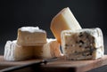 Assortment of cheeses on a wooden plate. Royalty Free Stock Photo