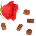 Assortment of chocolates and red rose isolated on white background. Flat lay, top view. Royalty Free Stock Photo