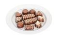 Assortment of chocolate candies on the white platter, 3D rendering Royalty Free Stock Photo