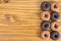 Assortment Of Chocolate And Plain Donuts On Wood Table Royalty Free Stock Photo