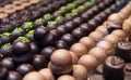 Assortment of chocolate pralines in pastry shop. Variety of sweet Swiss or Belgian candies in rows. Handmade desserts of