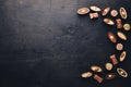 Assortment of chocolates with nuts. Black and milk chocolate. Wooden on the black surface. Top view