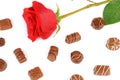 Assortment of chocolates and red rose isolated on white background. Flat lay, top view. Royalty Free Stock Photo