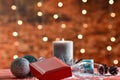 An assortment of Christmas decorations with an out of focus gift box and a champagne glass at the front. Christmas and decoration