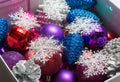 Assortment of Christmas decorative balls, pine cones and snowflakes in a box. Royalty Free Stock Photo