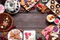 Assortment of Christmas holiday desserts and sweets. Top view frame over a wood background.