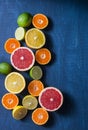 Assortment of citrus fruits on a blue background, top view. Oranges, grapefruit, tangerine, lime, lemon - organic fruits, vegetari