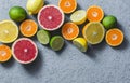 Assortment of citrus fruits on a grey background, top view. Oranges, grapefruit, tangerine, lime, lemon - organic fruits, vegetari