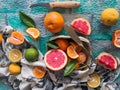 Assortment of citrus fruits, sliced and whole, with a knife on a blue background. Mixed tropical fruits lime, lemon, orange, Royalty Free Stock Photo