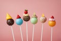 Assortment of colorful chocolate and fruit cake pops on stick on pink background, close-up. Sweets, lollipops and Royalty Free Stock Photo