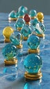 Assortment of colorful glass orbs with golden stands arranged on a blue wavy surface reflecting light, creating a Royalty Free Stock Photo