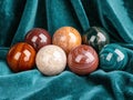 Assortment of colorful glass spheres on teal fabric Royalty Free Stock Photo