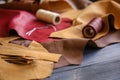 Assortment of colorful leather pieces with threads on table Royalty Free Stock Photo