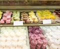 Assortment of Colorful macarons and meringue for sale in shop. sweets and cakes in candy shop, cafe showcase. Traditional french