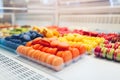 Assortment of colorful macaroons on cafe showcase. Variety of macaron flavours. Sweet almond cakes in store