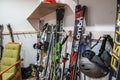 Assortment of colorful skis standing against wall in room at winter chalet