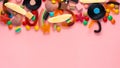 Assortment of colourful lollipops and candies on pink like background,  copy space, panorama Royalty Free Stock Photo