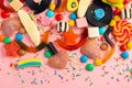 assortment of lollipops, fruit bonbon, candies and sprinkles on pink like background, copy space Royalty Free Stock Photo