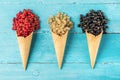 Assortment of currant berries black, red and white in waffle ice cream cone on blue wooden background Royalty Free Stock Photo