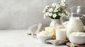 An assortment of dairy products on a light table, various types of cheeses and cottage cheese