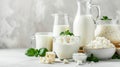 An assortment of dairy products on a light table, various types of cheeses and cottage cheese