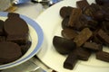 Assortment of dark, white and milk chocolate stack, chips. Chocolate and coffee beans on rustic wooden sacking background. Spices,