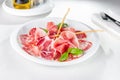 Assortment of delicatessen cold italian meat, salami, ham and bacon on dish. Selective focus