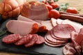 Assortment of delicious deli meats on slate plate