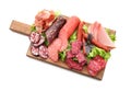 Assortment of delicious deli meats on wooden board, isolated on white