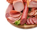 Assortment of delicious deli meats on wooden board, isolated on white Royalty Free Stock Photo