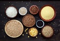 Assortment of different cereals and seeds in bowl: wheat, oats, barley, rice, millet, buckwheat, corn.