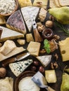 Assortment of different cheese types on stone background. Top view Royalty Free Stock Photo