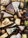 Assortment of different cheese types on stone background. Top view