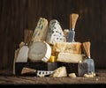 Assortment of different cheese types on wooden background. Cheese background