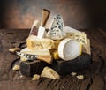 Assortment of different cheese types on wooden background. Cheese background