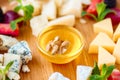Assortment of different cheeses on wooden platter Royalty Free Stock Photo