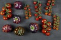 Assortment of different kinds of tomatoes and cherry tomatoes on black background