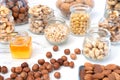 An assortment of different nuts in glass jars: hazelnuts, cashews, pistachios, pine nuts, walnuts, almonds and chickpeas. Royalty Free Stock Photo