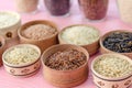 Assortment of different rice in bowls: white rice red rice black rice a mixture of wild and brown rice Royalty Free Stock Photo