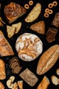 Assortment of different types of bread on a black background. Top view Royalty Free Stock Photo