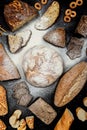 Assortment of different types of bread on a black background. Top view Royalty Free Stock Photo