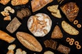 Assortment of different types of bread on a black background. Top view Royalty Free Stock Photo