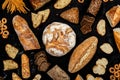 Assortment of different types of bread on a black background. Top view Royalty Free Stock Photo